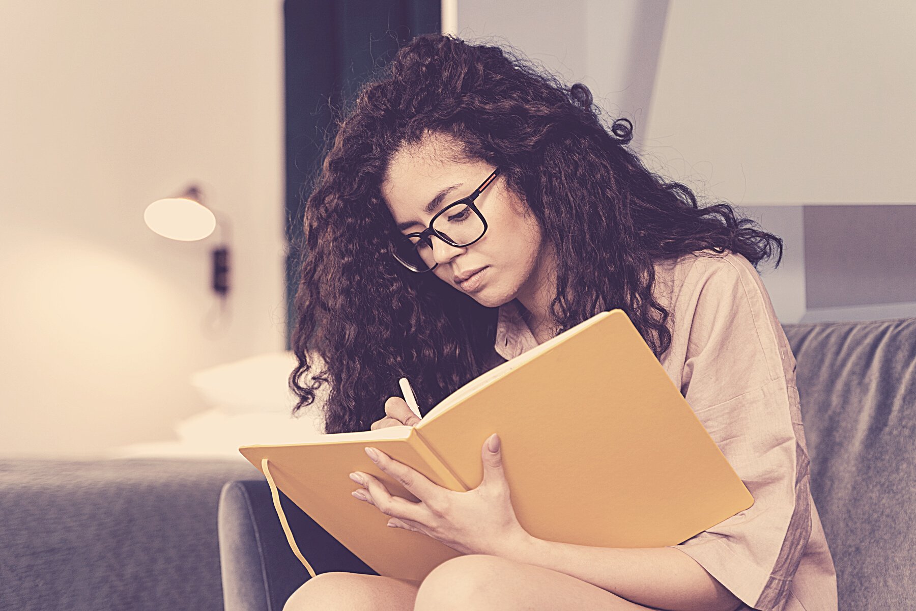 A Young Woman Writing in a Diary