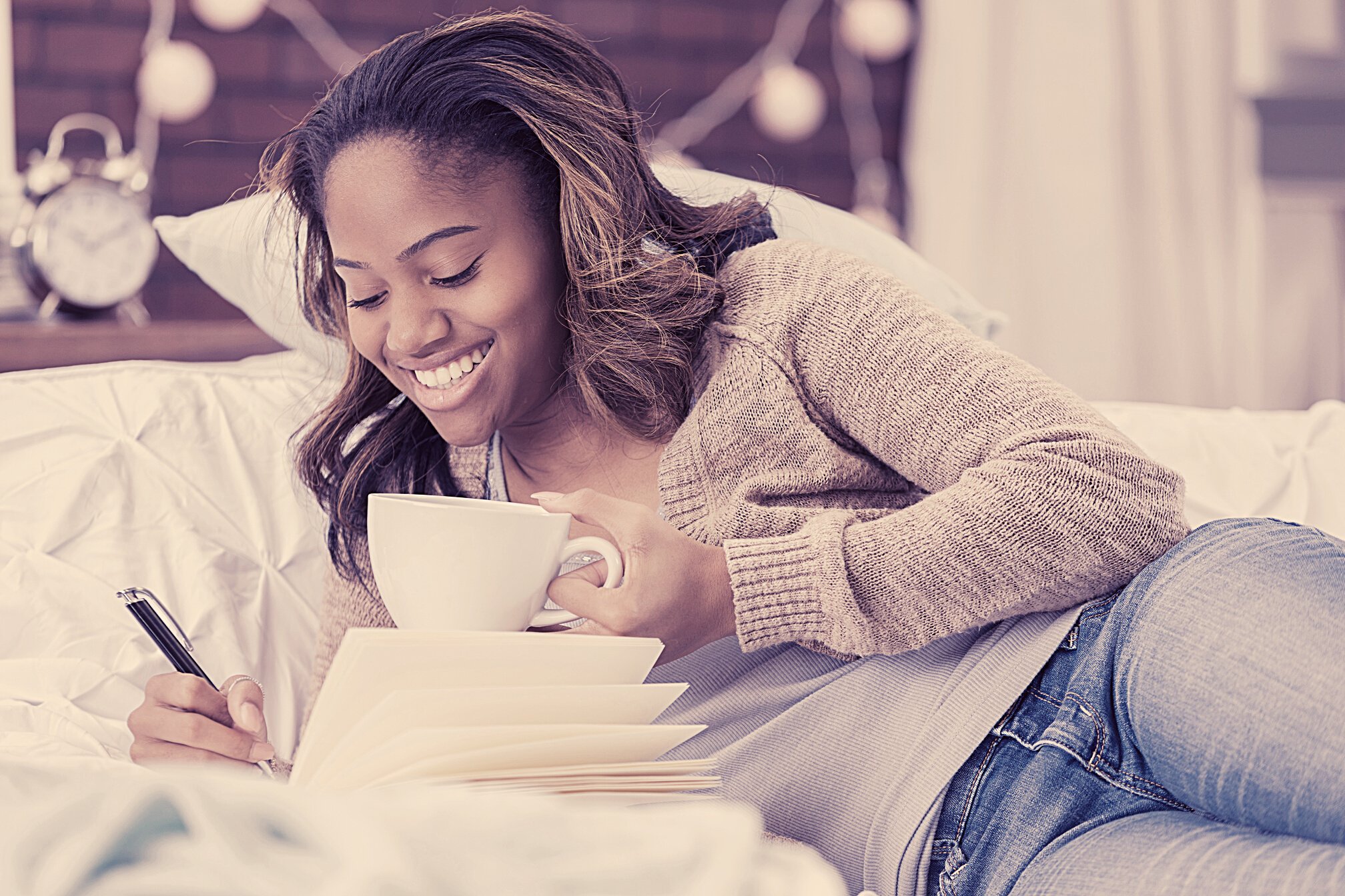 African American woman writes in journal